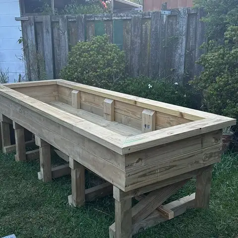 The timber raised bed, built and empty, on the lawn.